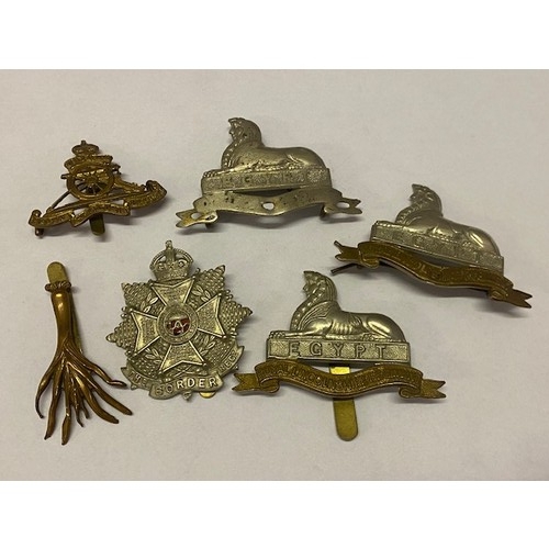 350 - Two Royal Lincolnshire Regiment Egypt cap badges, one other, a Royal Artillery cap badge, The Border... 