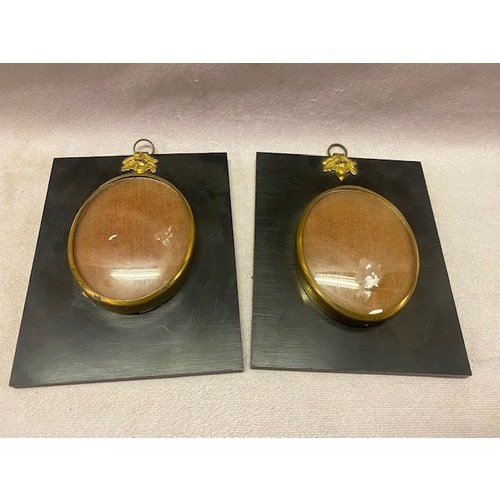 18 - Two oval brass miniature frames on ebonised plinths - 3in. x 2 1/2in.