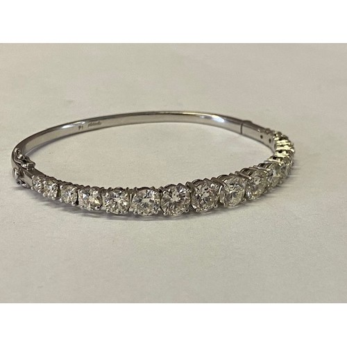 314 - A Platandia stiff hinged bangle set with seventeen graduated round brilliant cut diamonds to the top... 