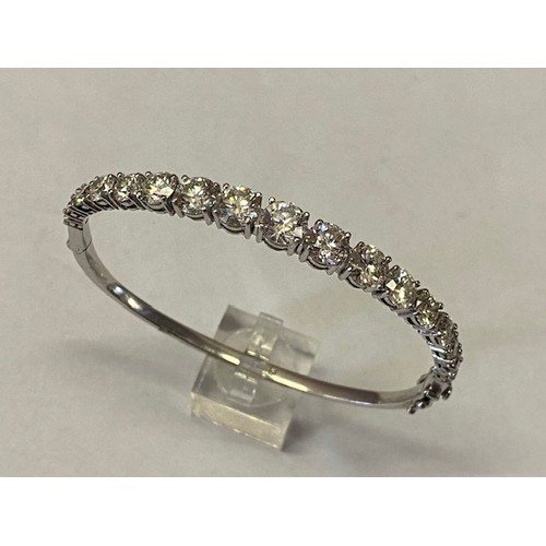 314 - A Platandia stiff hinged bangle set with seventeen graduated round brilliant cut diamonds to the top... 