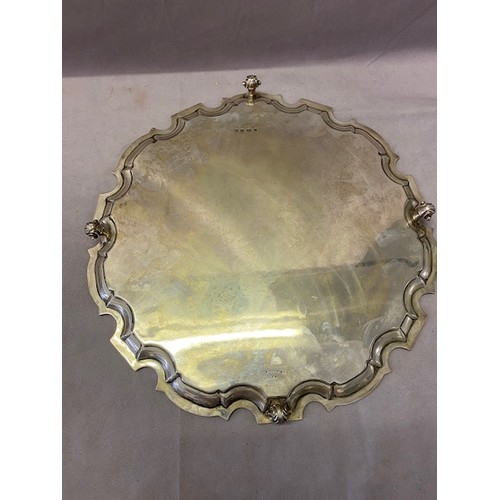 250 - A large silver salver with Chippendale style border, raised on three scroll feet - Sheffield 1932, m... 