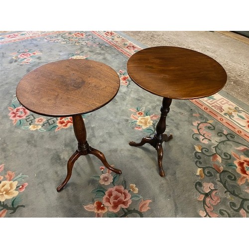 108 - Two Georgian mahogany wine tables with circular tops, on baluster turned columns and three downswept... 