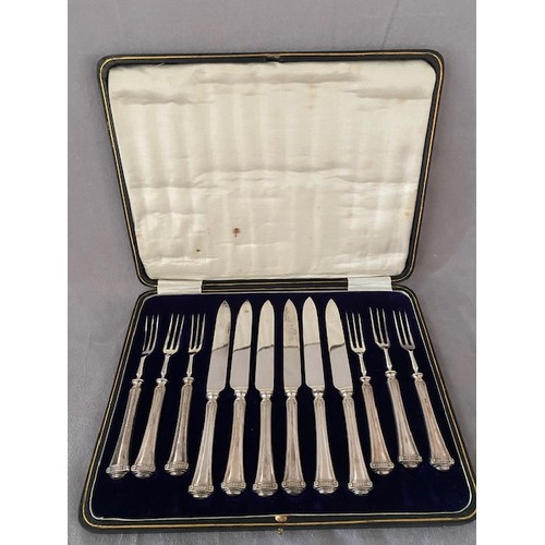 143 - A set of six pairs of fruit knives and forks with silver covered handles - Sheffield 1915, marks for... 