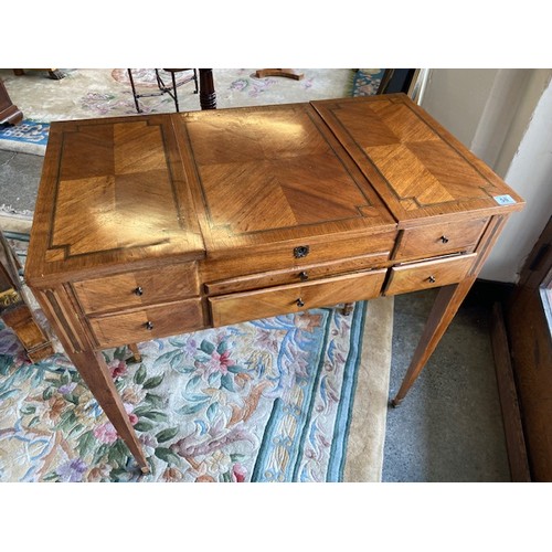 50 - A Continental kingwood dressing table fitted hinged mirror compartment to the centre  flanked to one... 