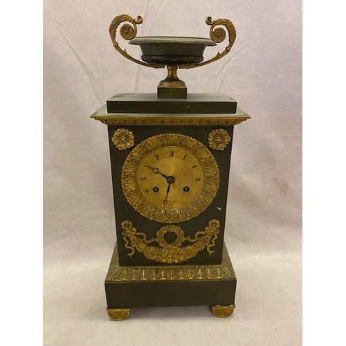 324 - A French Empire design mantel clock with gilded dial, striking movement on a bell, in a steel case w... 