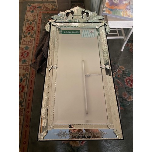 46 - A reproduction Venetian style wall mirror with scroll pediment - 47in. x 19in.