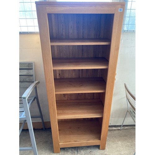 110 - A modern oak openfront bookcase fitted four shelves - 28in. wide