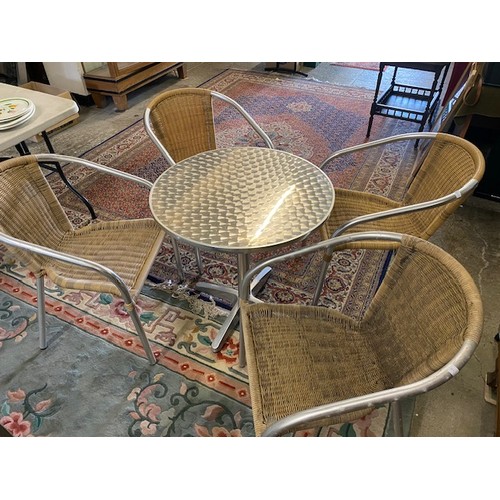 105 - An aluminium patio table and four matching chairs