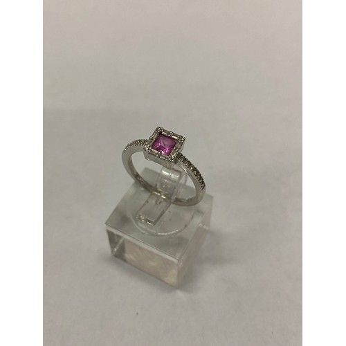 178 - A lady's ring set centre pink Princess cut stone surrounded by diamonds, diamond set shoulders, on a... 