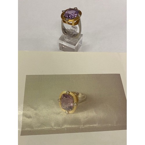 176 - A lady's ring set centre amethyst with small brilliant cut diamond to each side, in a brushed 18kt. ... 