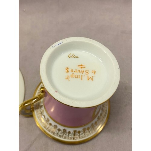 111 - A Sevres porcelain cabinet cup and saucer, the cup with gilt scroll handle, white and gilt rim, pink... 