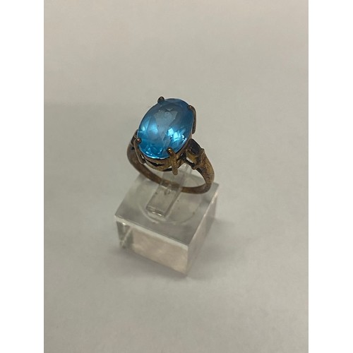 189 - A lady's ring set blue stone, on a 9ct. gold shank