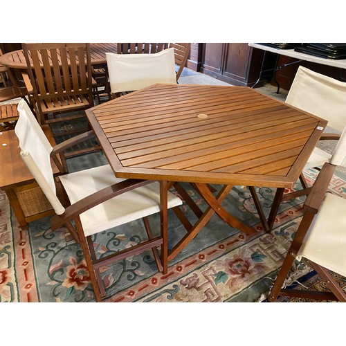 57 - A teak finished folding garden table and four folding director style chairs