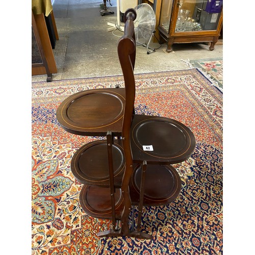 42 - An Edwardian mahogany and satinwood inlaid three tier folding cakestand