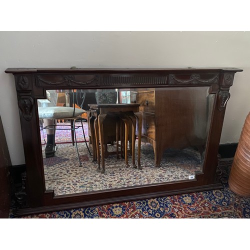 50 - An Edwardian bevelled overmantel in a mahogany frame with swag and fluted decoration - 32in. x 51in.