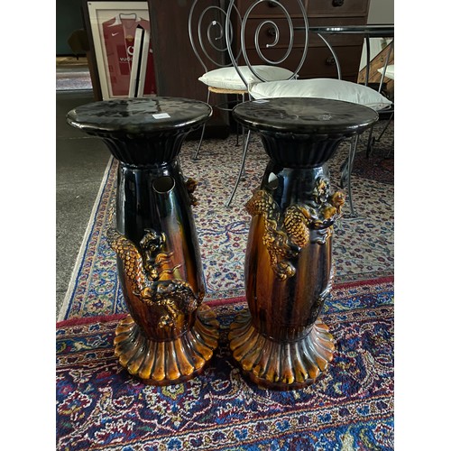 110 - A pair of Victorian pottery jardiniere stands, green and black treacle glaze with applied decoration... 