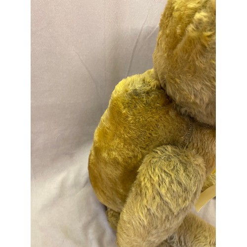 302 - A large early 20th Century golden mohair teddy bear with growler, articulated limbs, replacement paw... 