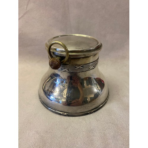 195 - An Edwardian silver desk inkwell, the hinged lid with inset pocket watch with white enamel dial and ... 