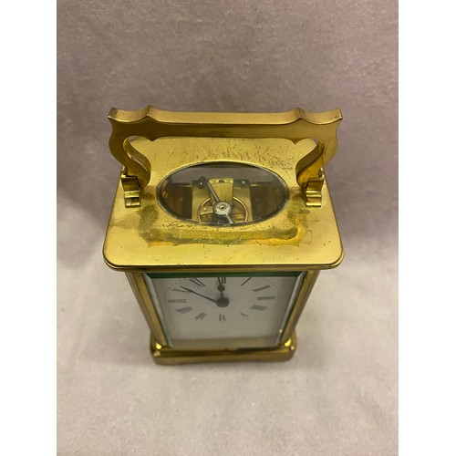 305 - A carriage clock, white enamel dial, in a bevelled glass and brass case - 4 1/4in. high