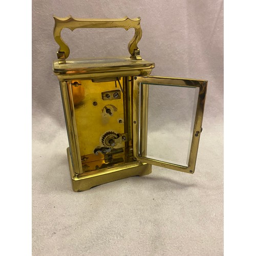 305 - A carriage clock, white enamel dial, in a bevelled glass and brass case - 4 1/4in. high