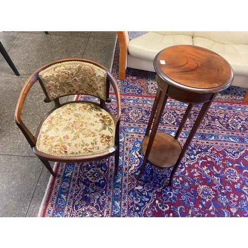 25 - A reproduction mahogany two tier plant stand with circular top and undertier, on splayed legs and an... 