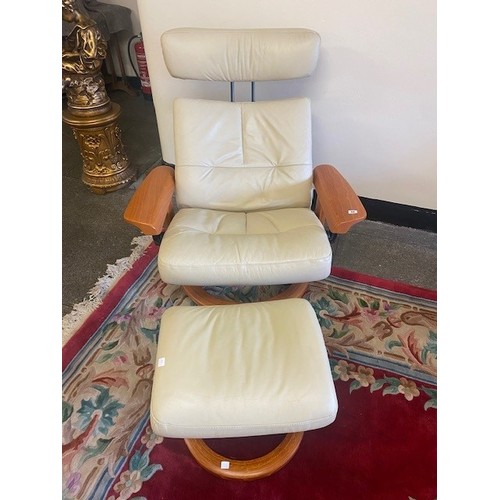 52 - An Ekorness Stressless cream leather reclining armchair and stool