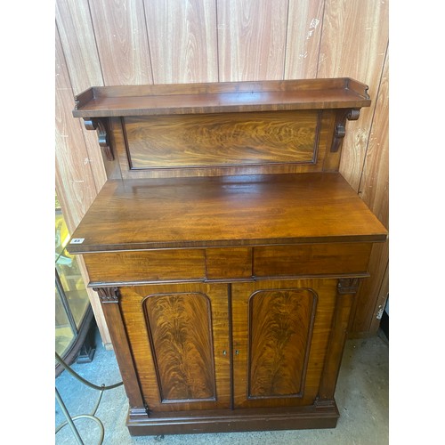 65 - A 19th Century mahogany chiffonier, the raised back fitted shelf with scroll supports, the base fitt... 