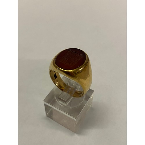 187 - A gentleman's signet ring set carved carnelian, on an 18kt. gold shank