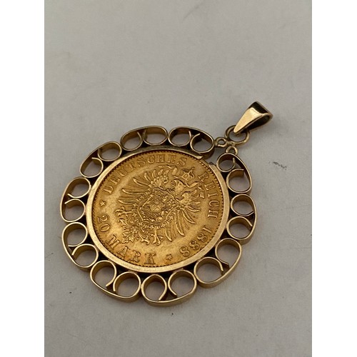 207 - A gold 20 Mark coin dated 1888 mounted in a 9ct. gold frame as a pendant