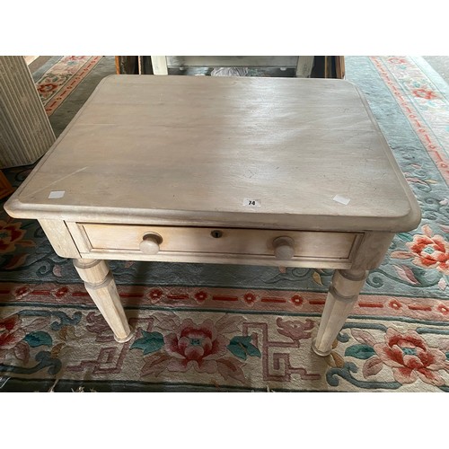 67 - A limed pine table with square top, frieze drawer, on panelled legs - 28 1/2in. wide