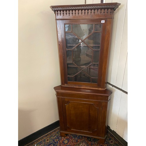 71 - A Georgian design mahogany floor standing angle cabinet, the upper part fitted glass panelled door w... 