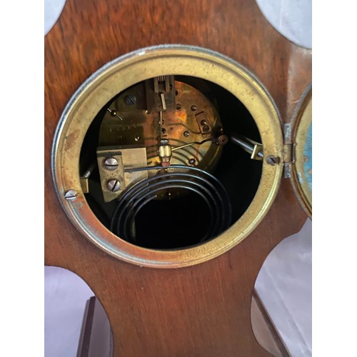 257 - An Edwardian mantel clock with cream enamel chapter ring, striking movement on a gong, in a mahogany... 