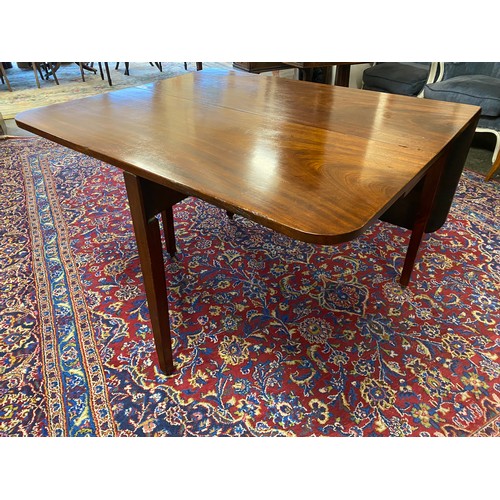 46 - A Georgian mahogany dining table fitted two deep drop flaps, on square legs - 41 1/2in. wide