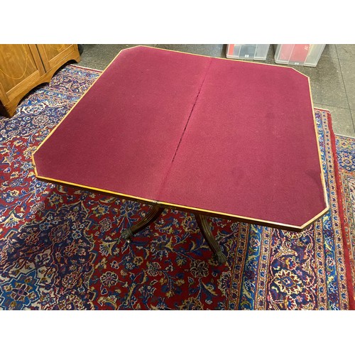 50 - A Regency mahogany and brass inlaid card table with rectangular hinged top, canted corners, on panel... 