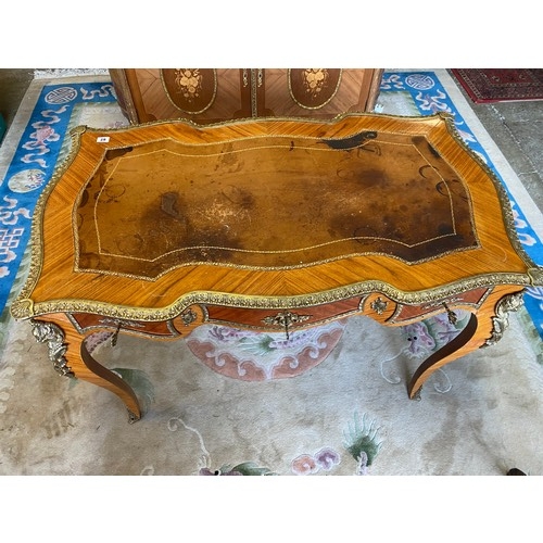 62 - A reproduction kingwood bureau plat with inset brown and gilt tooled leather top, frieze drawer, gil... 