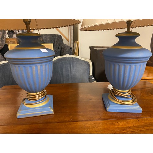 66 - A pair of matt blue and gold sprayed tablelamp bases of urn form, complete with shades