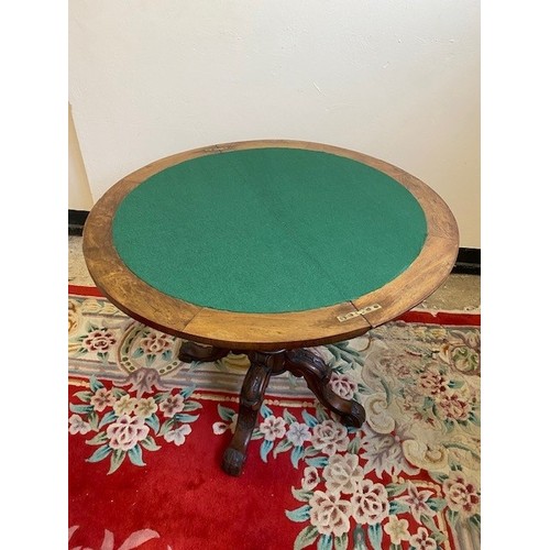 45 - A Victorian walnut veneered card table with half round folding top enclosing green baize lined inter... 