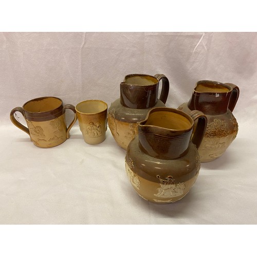 169 - Three Doulton stoneware jugs, a loving cup and a beaker