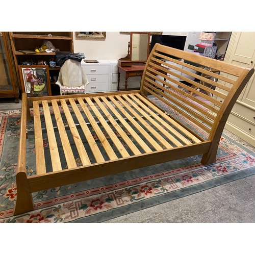 77 - A modern 6ft. 6in. oak bed frame