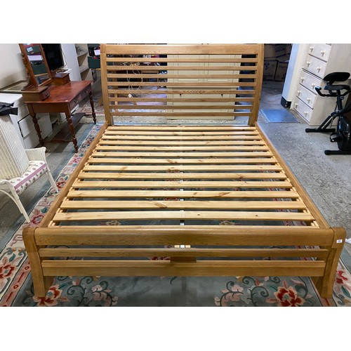 77 - A modern 6ft. 6in. oak bed frame