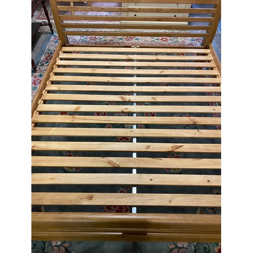 77 - A modern 6ft. 6in. oak bed frame