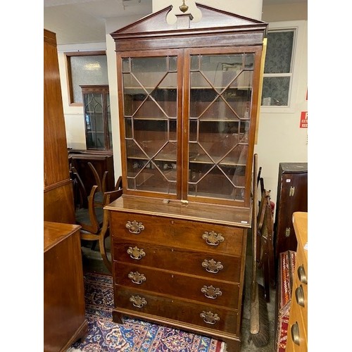 51 - A Georgian mahogany bookcase, the upper part with broken arched pediment, brass orb with griffin sur... 