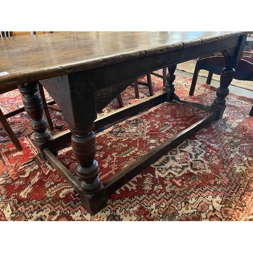 112 - An antique oak refectory style table with rectangular top, carved frieze, on baluster turned legs un... 