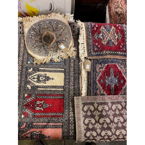 3 - An Eastern prayer rug with four medallions, fringed - 36in. x 17 1/2in. and three other small Easter... 