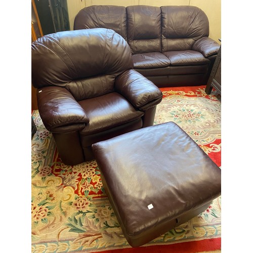 73 - A modern brown leather three seater settee, armchair and pouffe