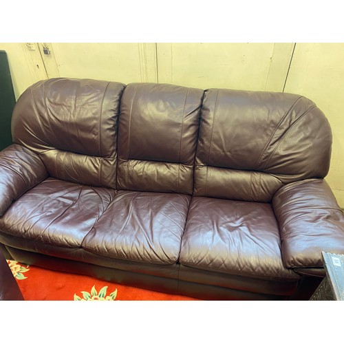 73 - A modern brown leather three seater settee, armchair and pouffe