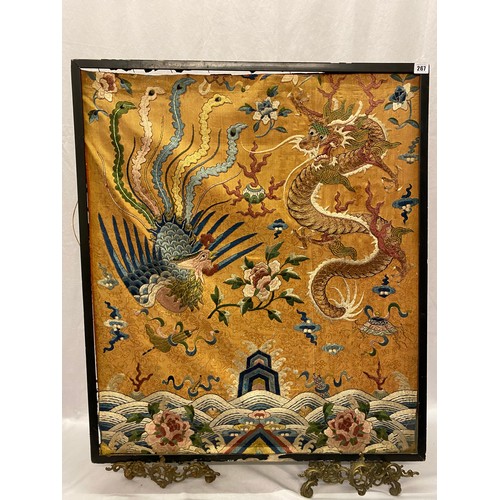 267 - A Chinese embroidered silk panel of a dragon and exotic bird, framed - 28 1/2in. x 34in.