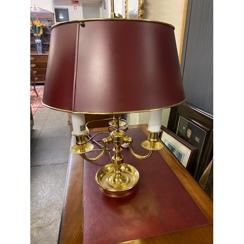 79 - A brass three branch desk lamp with red sprayed metal shade