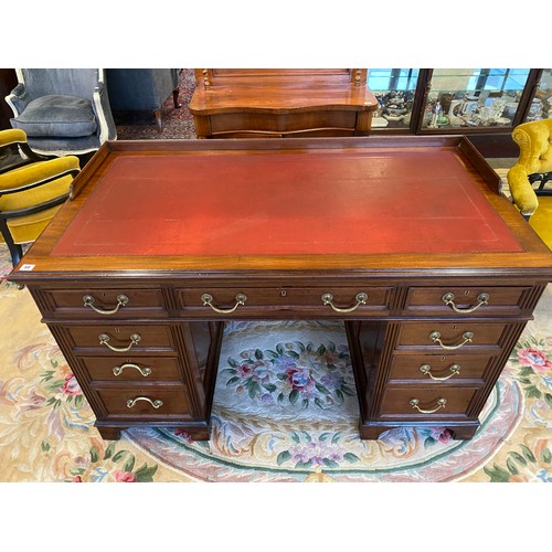 116 - A large Victorian mahogany pedestal desk with three quarter galleried top inset red leather writing ... 