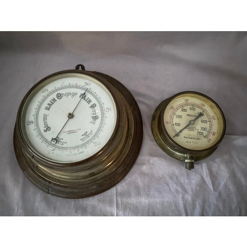 253 - A ships barometer retailed by John Barker and Co. Kensington in a brass case and a water pressure ga... 